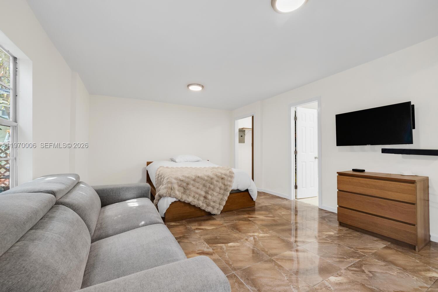 645 Northeast 62nd Street Miami, FL 33138 - Photo 29 of 32 a living room with furniture and a flat screen tv