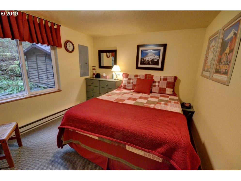 28260 Road 12, Unit LOT35 Rhododendron, OR 97049 - Photo 14 of 30 a bedroom with a bed and wooden floor
