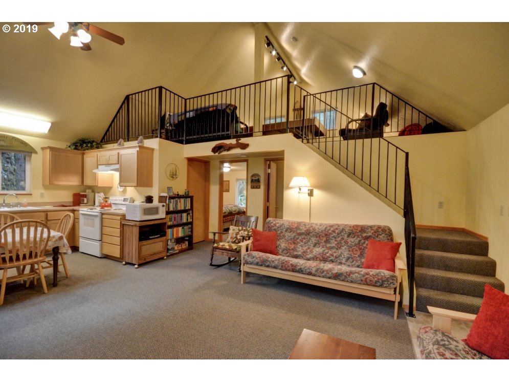 28260 Road 12, Unit LOT35 Rhododendron, OR 97049 - Photo 9 of 30 a living room with furniture and a chandelier