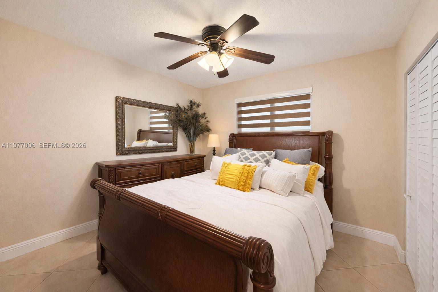12901 Southwest 191st Street Miami, FL 33177 - Photo 12 of 27 a bedroom with a bed and a chandelier