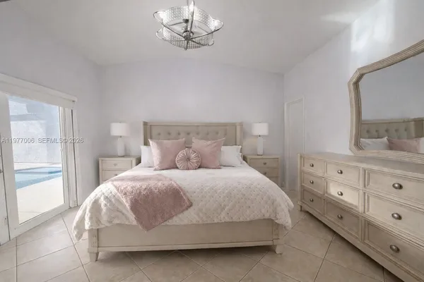 a bedroom with a bed and window with lamp