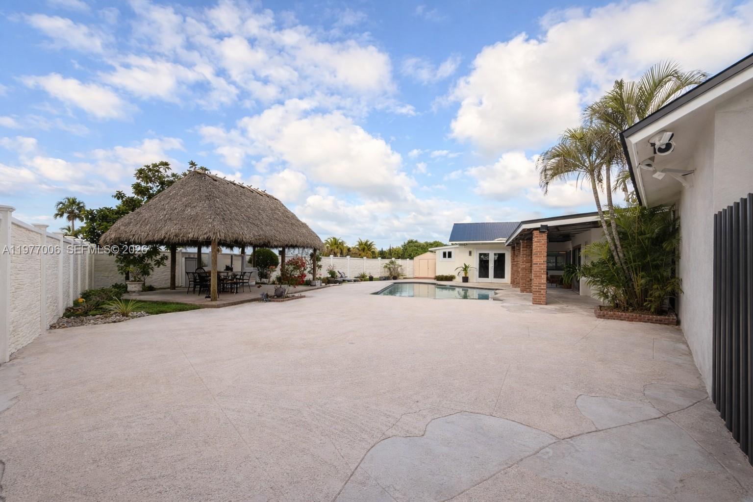 12901 Southwest 191st Street Miami, FL 33177 - Photo 18 of 27 a couple of cars parked in front of a house