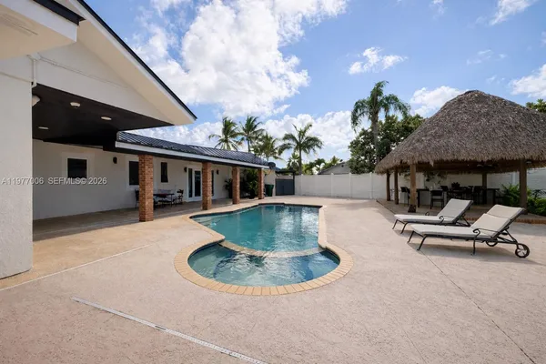 an outdoor space with seating area and barbeque oven