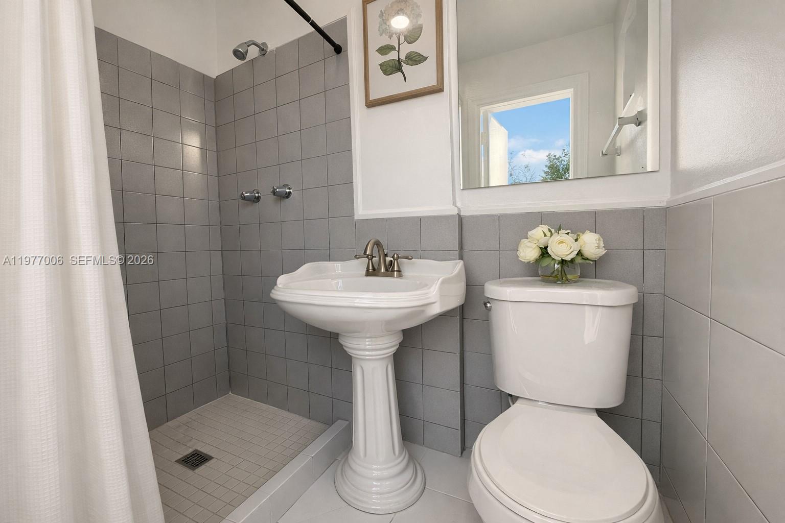12901 Southwest 191st Street Miami, FL 33177 - Photo 20 of 27 a bathroom with a sink toilet and shower
