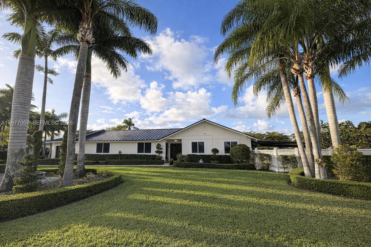 12901 Southwest 191st Street Miami, FL 33177 - Photo 2 of 27 a front view of a house with a garden
