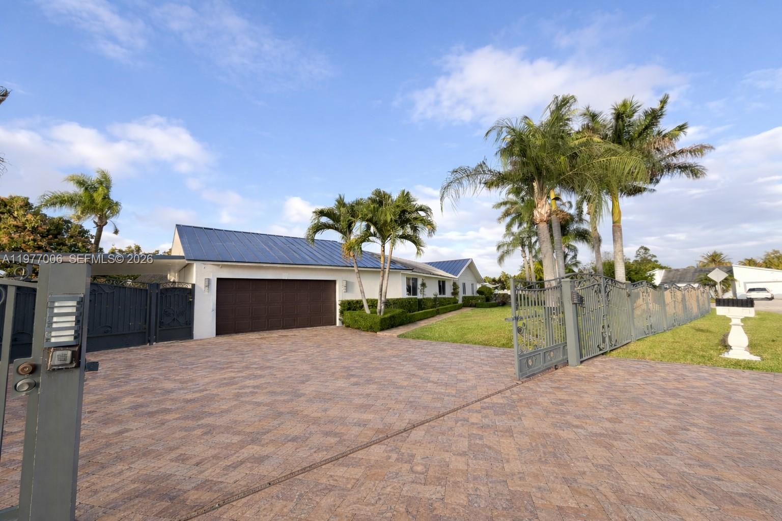 12901 Southwest 191st Street Miami, FL 33177 - Photo 24 of 27 a view of a house with a yard and potted plants