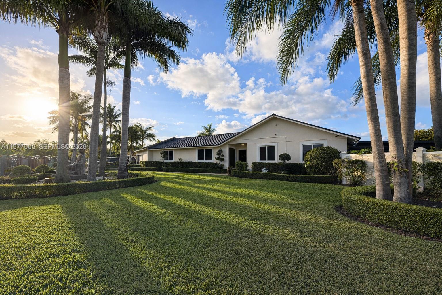 12901 Southwest 191st Street Miami, FL 33177 - Photo 25 of 27 a front view of a house with garden