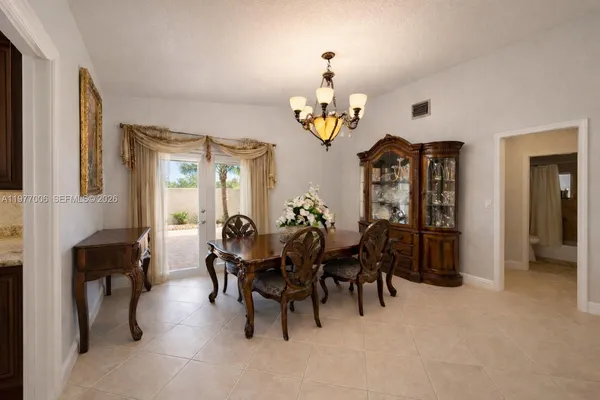 a view of a dining room with furniture and chandelier