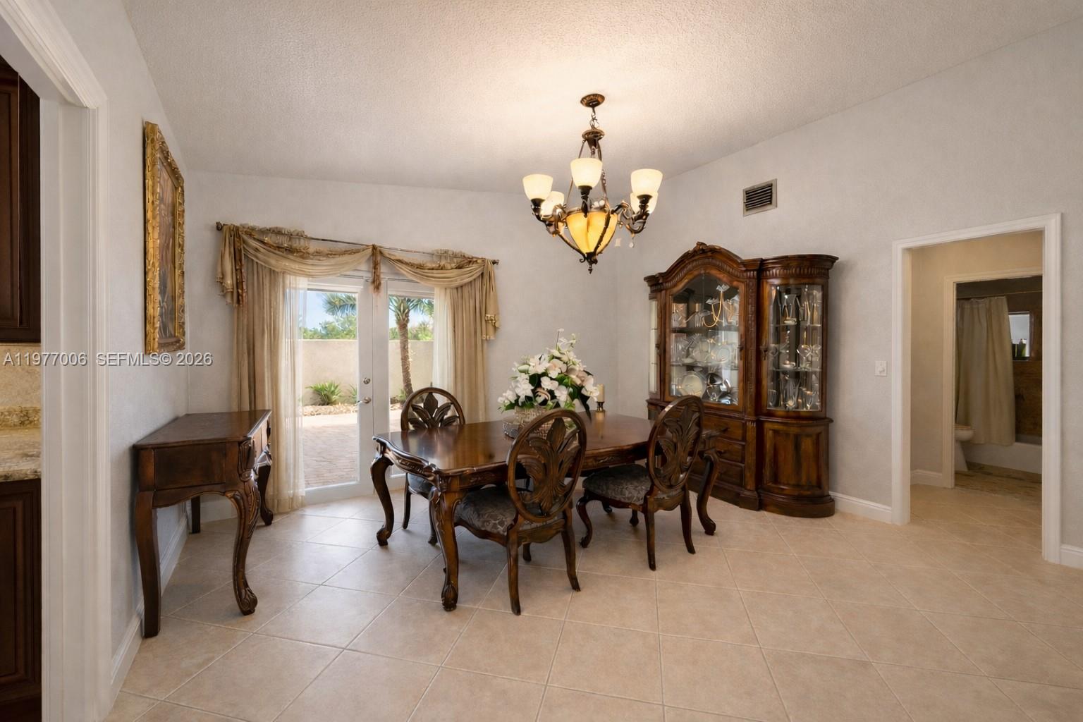 12901 Southwest 191st Street Miami, FL 33177 - Photo 5 of 27 a view of a dining room with furniture and chandelier
