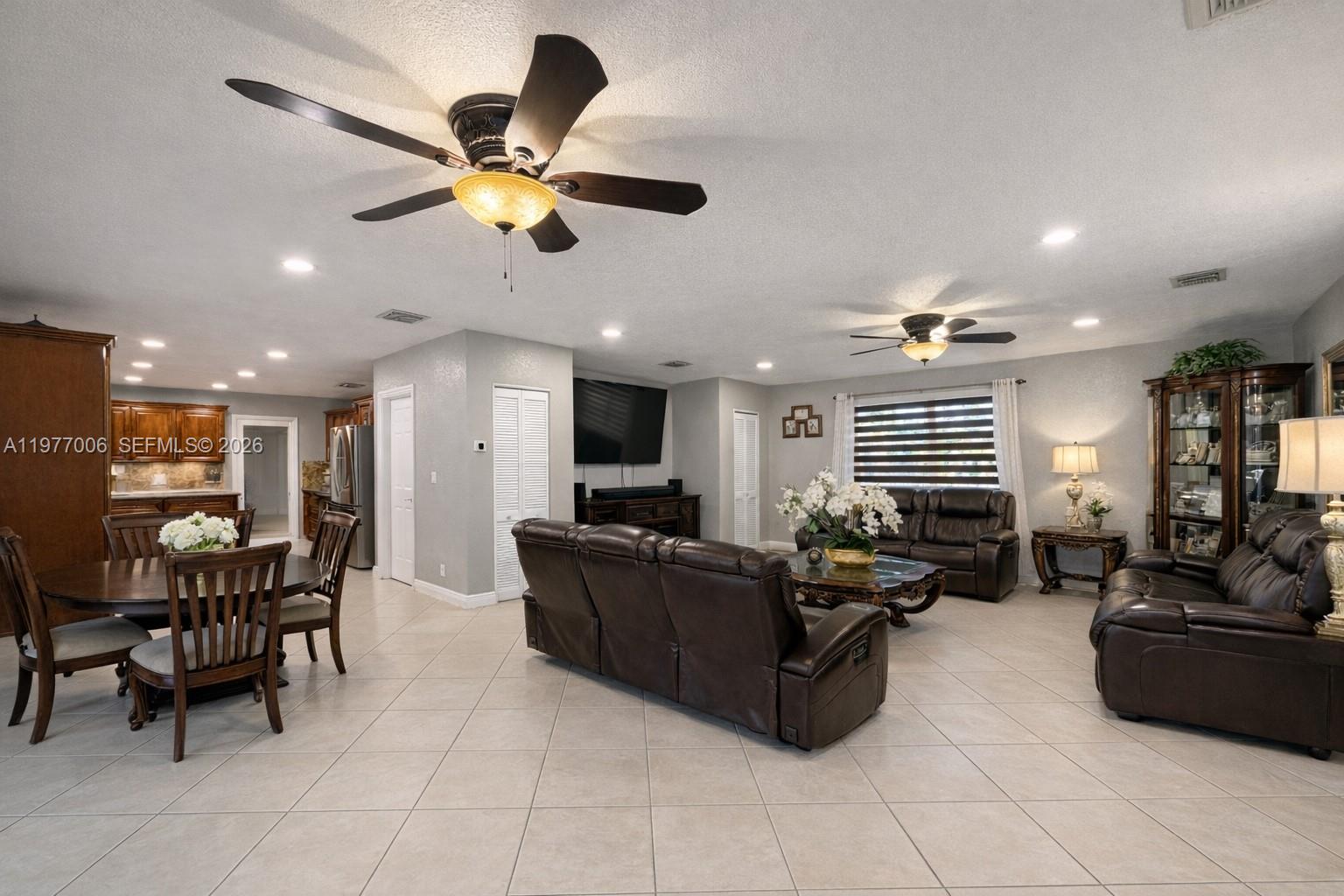 12901 Southwest 191st Street Miami, FL 33177 - Photo 7 of 27 a living room with furniture ceiling fan and a window