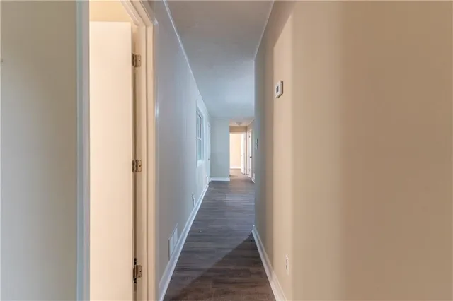 a view of a hallway with a wooden floor