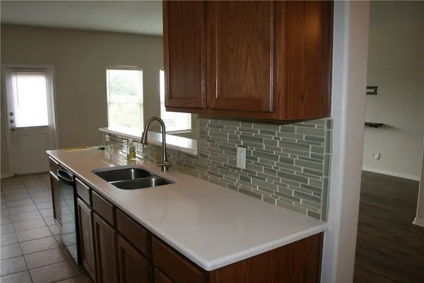 a kitchen with a sink and a wooden cabinets