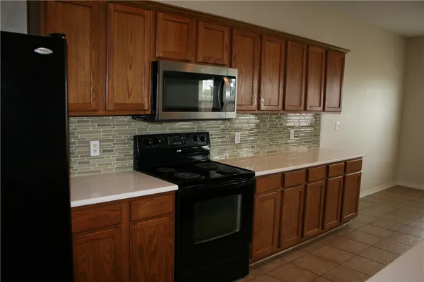 a kitchen with stainless steel appliances granite countertop a stove microwave and sink