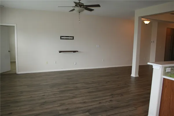 a view of a room with wooden floor