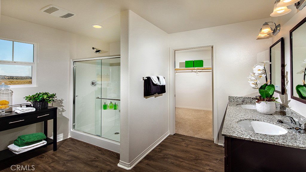 14068 Hera Place Beaumont, CA 92223 - Photo 9 of 14 a bathroom with a granite countertop sink and a mirror