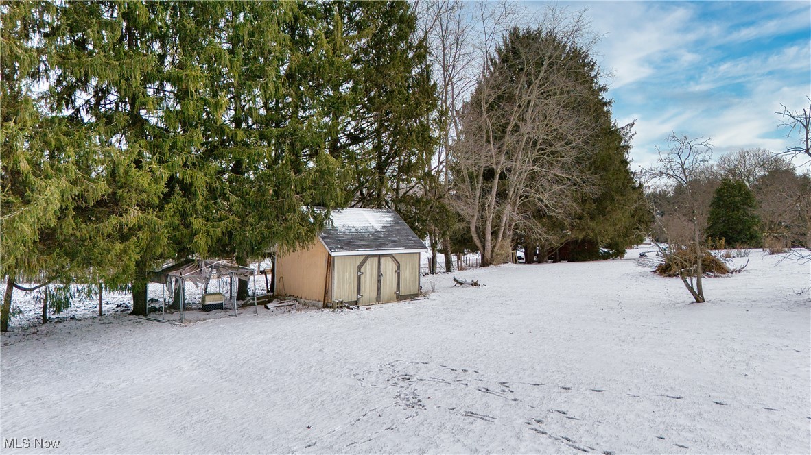 6160 Dresden Road Zanesville, OH 43701 - Photo 30 of 32 Snowy yard with a shed