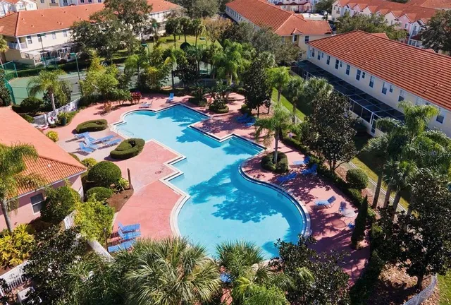 an aerial view of a house with yard swimming pool and outdoor seating