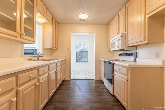 a kitchen with sink cabinets and a window