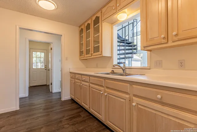 a kitchen with stainless steel appliances granite countertop a sink and dishwasher with wooden floor