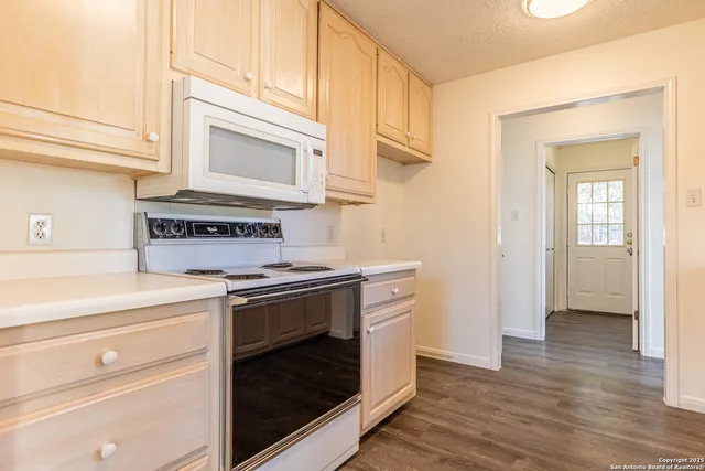 a kitchen with a stove and a microwave