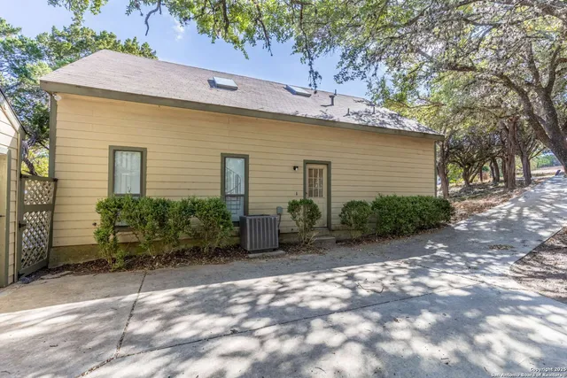a backyard of a house with plants and trees