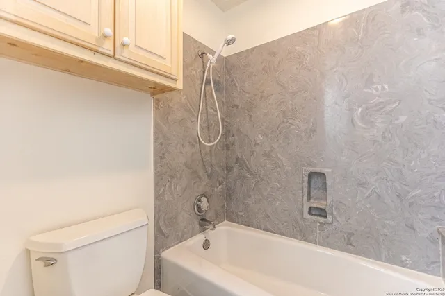 a bathroom with a bathtub and shower