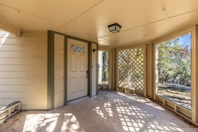 a view of a hallway with wooden walls