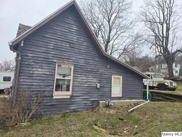 a view of house with backyard of house