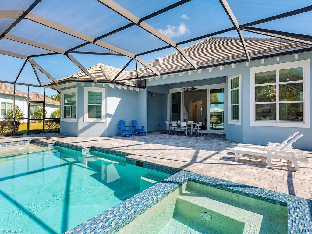 6399 Warwick Avenue Naples, FL 34113 - Photo 2 of 30 a view of a backyard with table and chairs under an umbrella