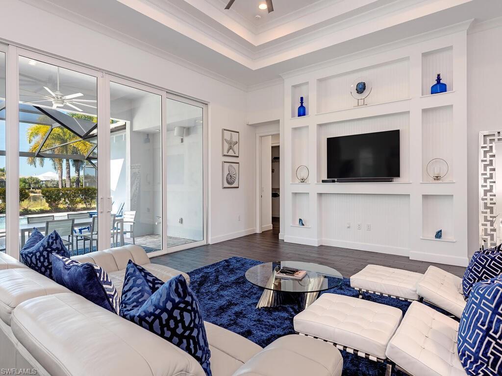 6399 Warwick Avenue Naples, FL 34113 - Photo 3 of 30 a living room with furniture and a flat screen tv