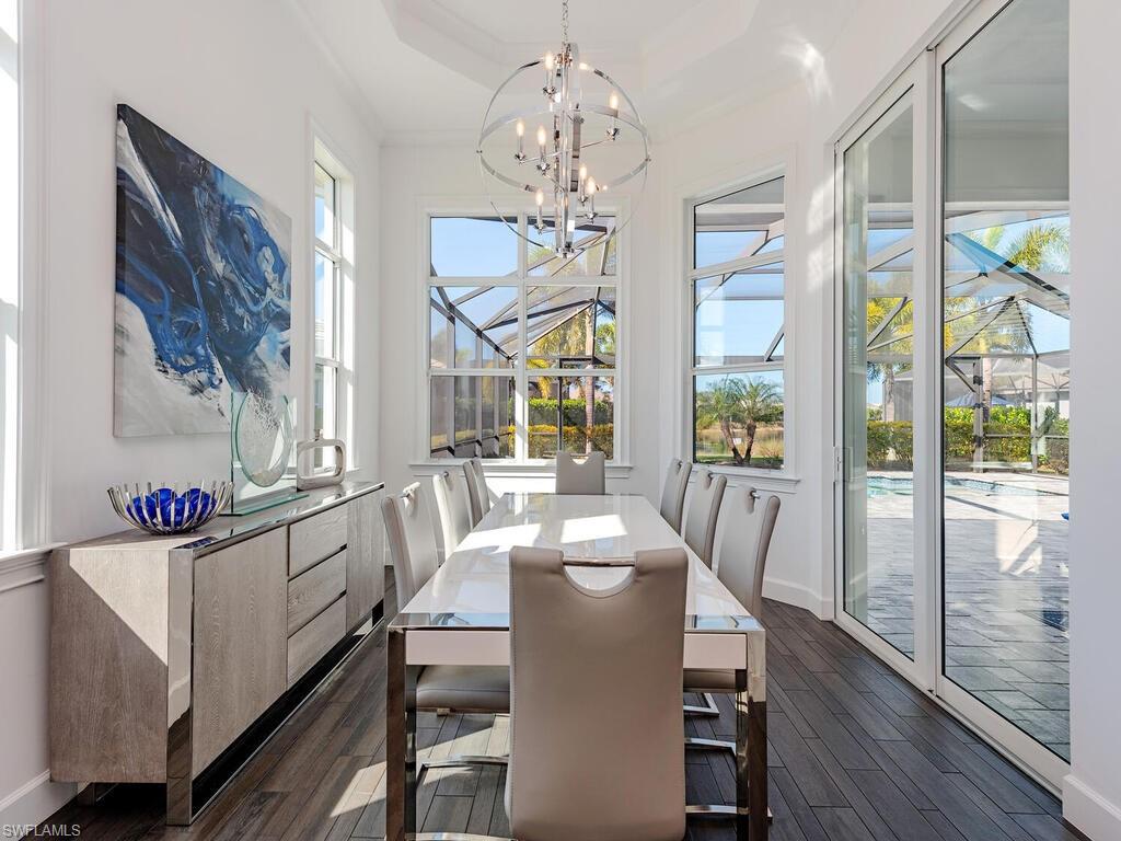 6399 Warwick Avenue Naples, FL 34113 - Photo 5 of 30 a view of a dining room with furniture a chandelier and wooden floor