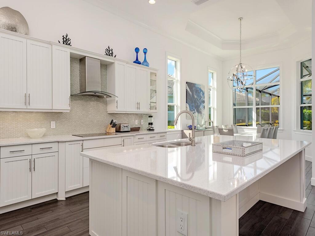 6399 Warwick Avenue Naples, FL 34113 - Photo 6 of 30 a kitchen with kitchen island granite countertop a sink a stove and cabinets