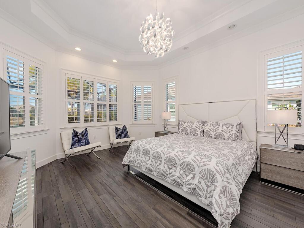 6399 Warwick Avenue Naples, FL 34113 - Photo 9 of 30 a bedroom with bed and a large window