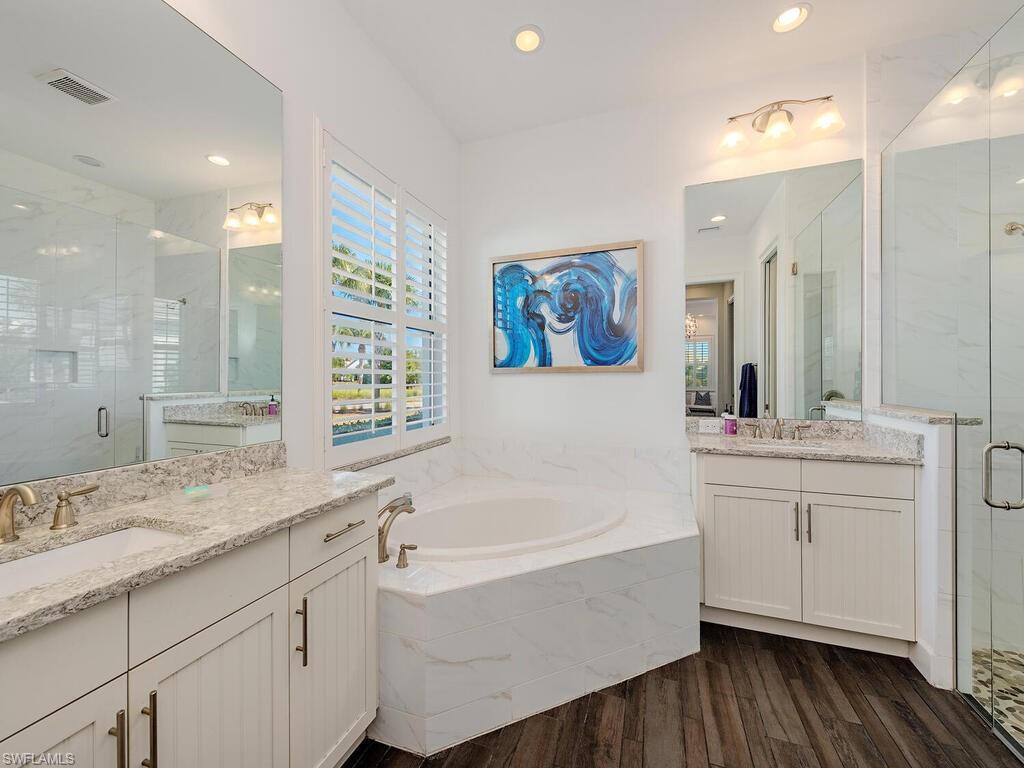 6399 Warwick Avenue Naples, FL 34113 - Photo 10 of 30 a bathroom with a granite countertop sink mirror and bathtub