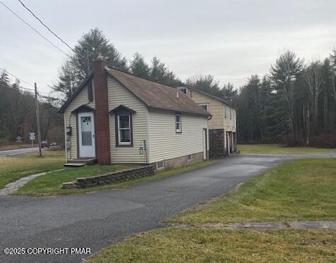 558 Effort Neola Road Brodheadsville, PA 18353 - Photo 4 of 6 a view of a small white house next to a yard and large trees