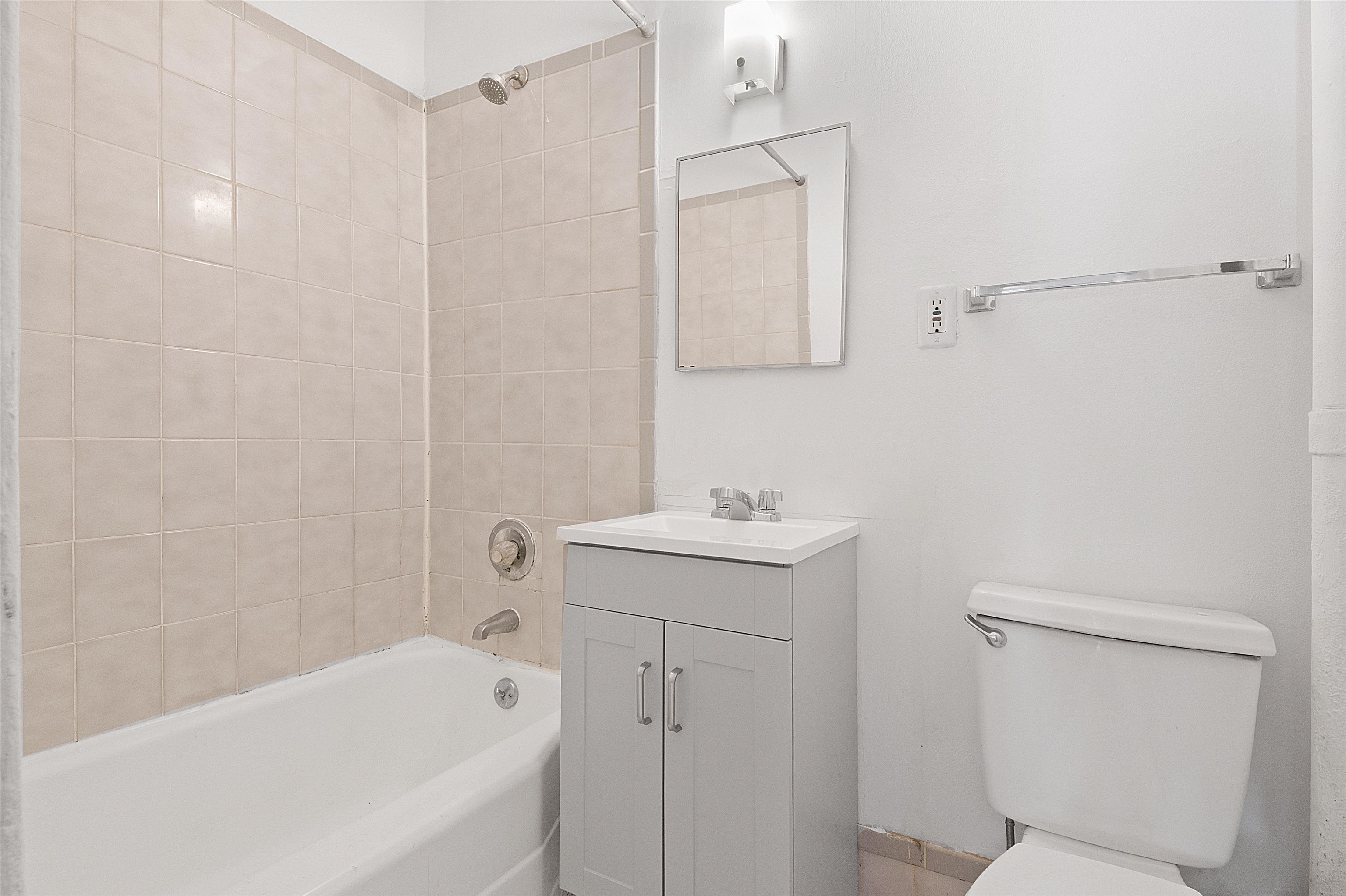 410 Washington Street, Unit 5 Hoboken, NJ 07030 - Photo 13 of 15 a bathroom with a sink a toilet and shower