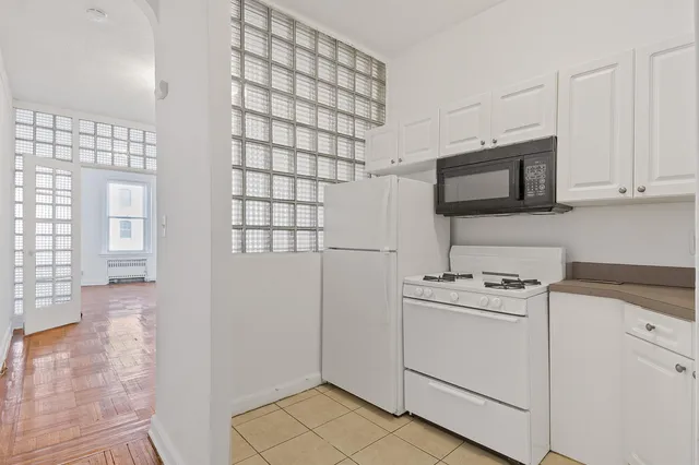 a kitchen with a stove microwave and sink