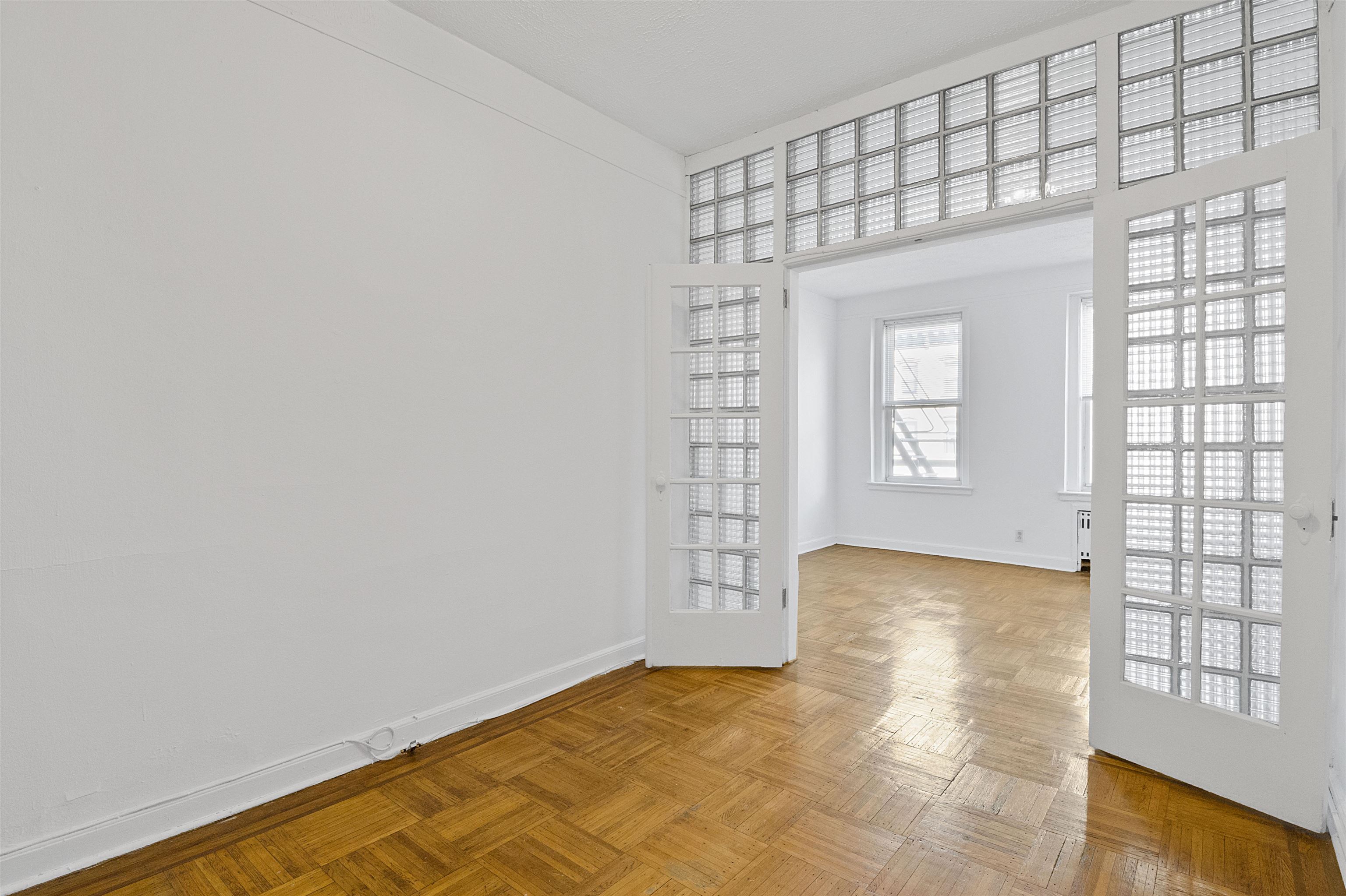 410 Washington Street, Unit 5 Hoboken, NJ 07030 - Photo 6 of 15 a view of an empty room and window
