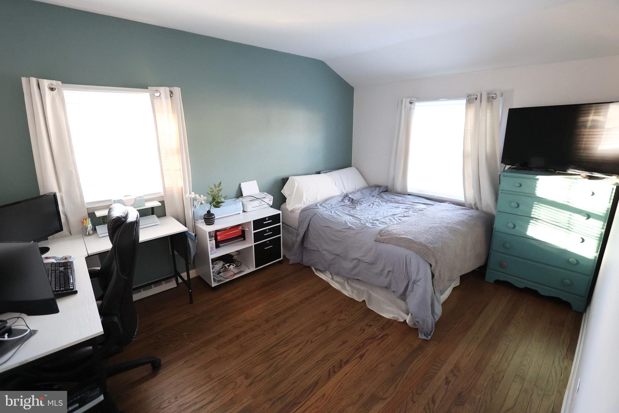 1036 Surrey Road Somerdale, NJ 08083 - Photo 12 of 23 a bedroom with a bed a flat screen tv and a window