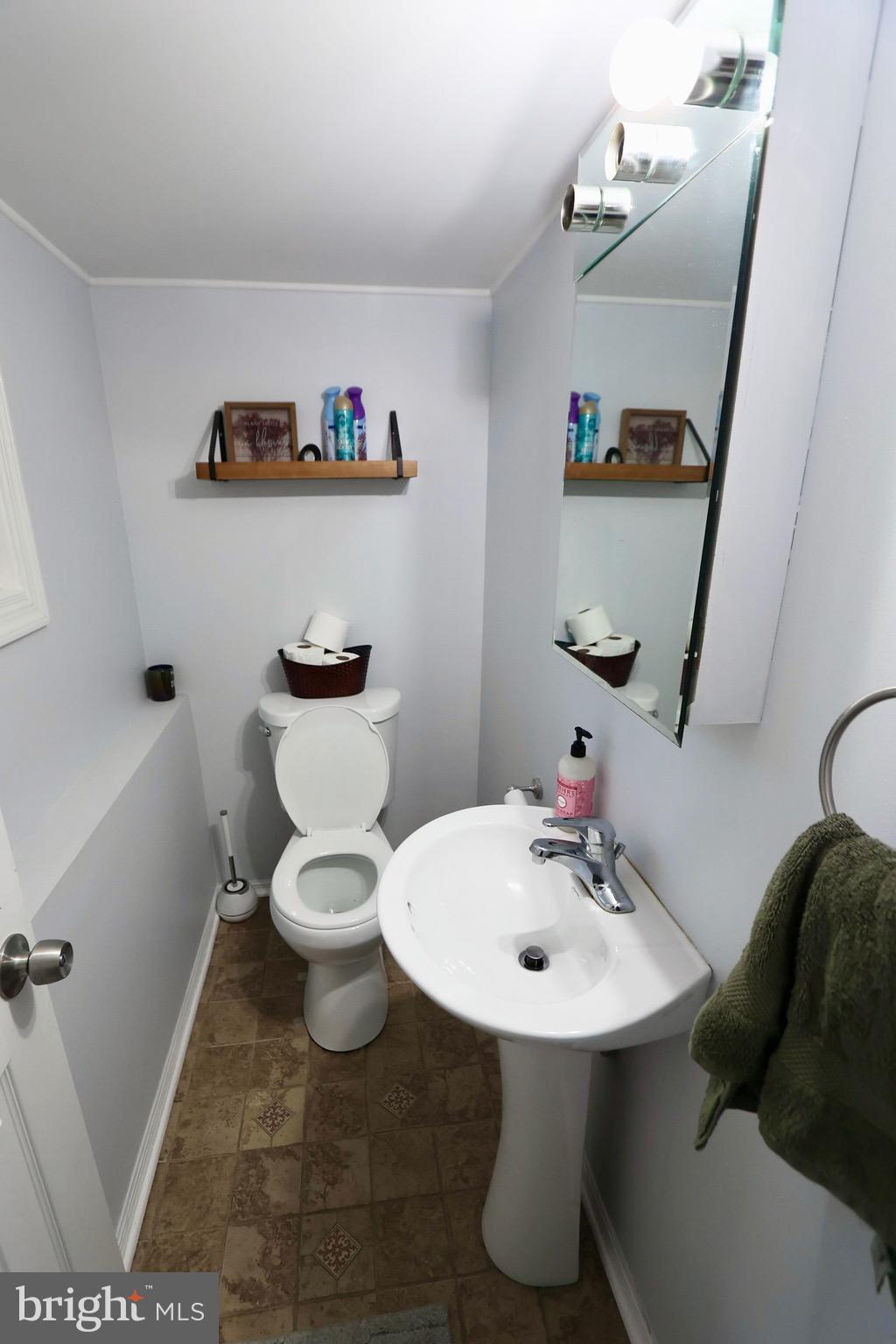 1036 Surrey Road Somerdale, NJ 08083 - Photo 18 of 23 a bathroom with a sink a toilet and a mirror