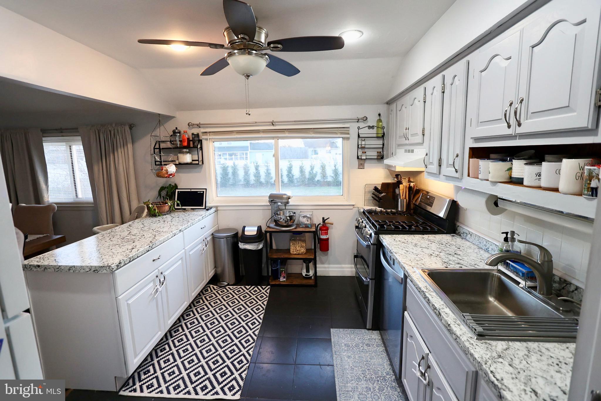 1036 Surrey Road Somerdale, NJ 08083 - Photo 2 of 23 a kitchen that has a sink and a stove in it