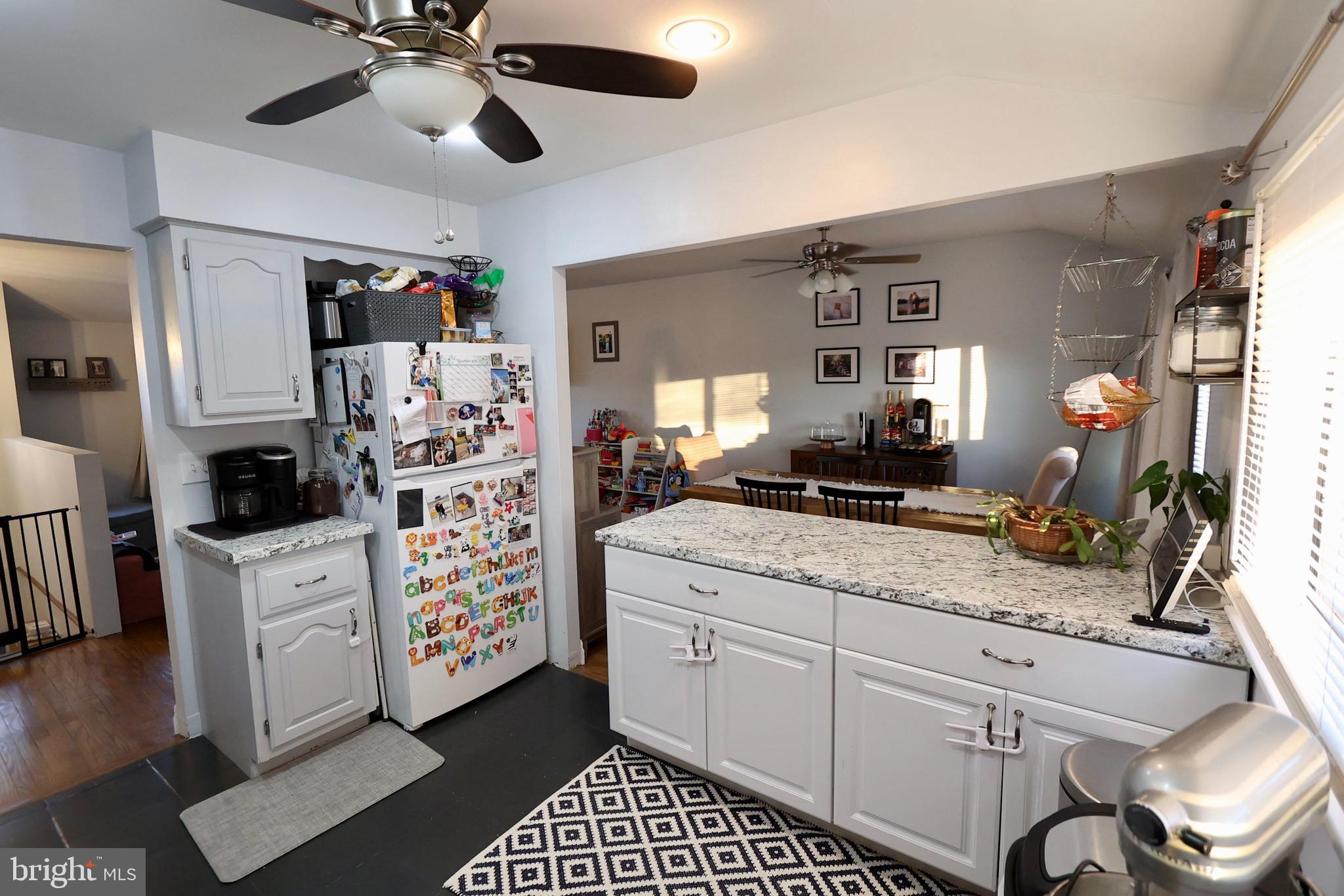 1036 Surrey Road Somerdale, NJ 08083 - Photo 3 of 23 a kitchen with stainless steel appliances kitchen island granite countertop a refrigerator and a stove top oven