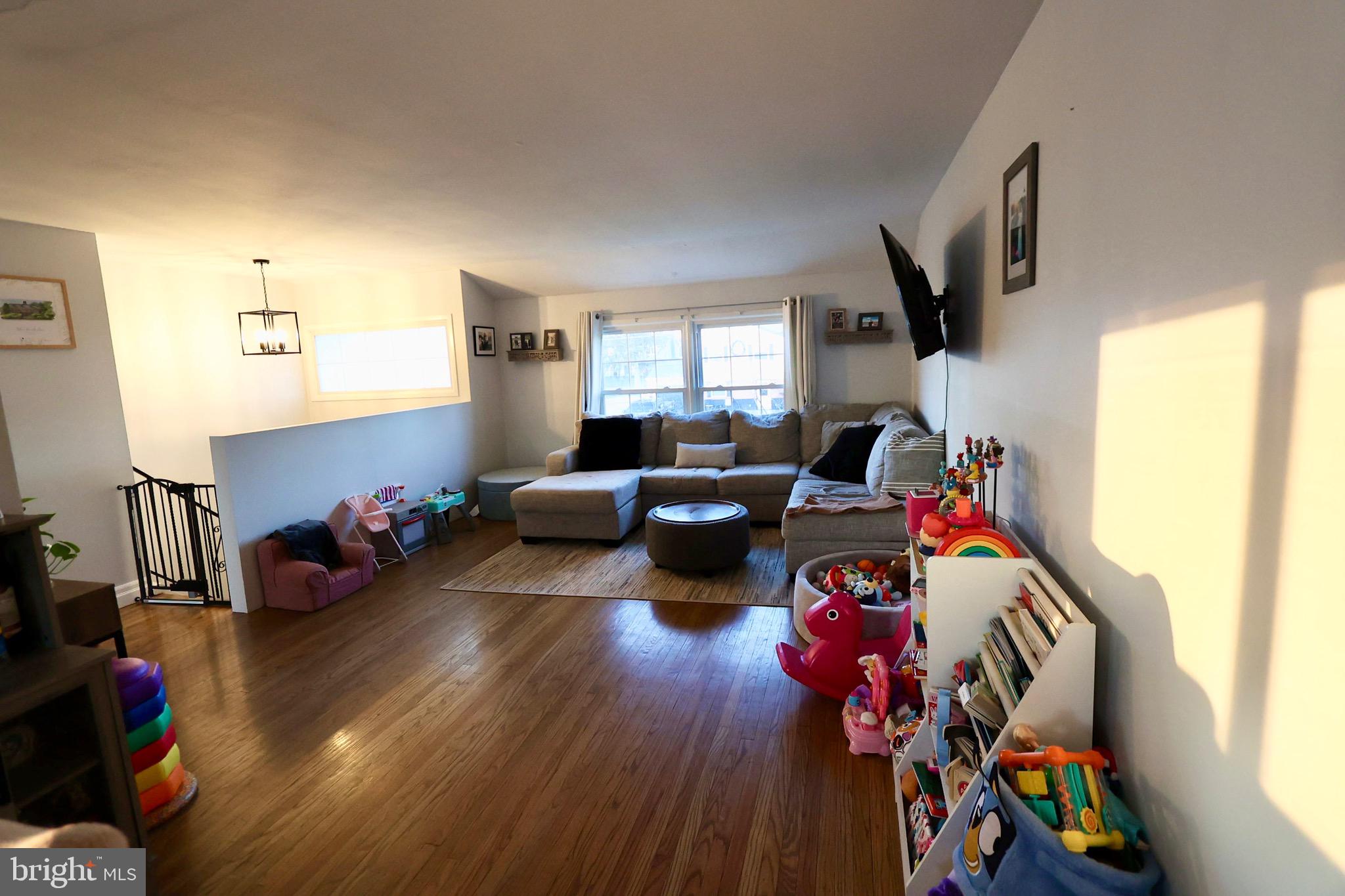1036 Surrey Road Somerdale, NJ 08083 - Photo 5 of 23 a living room with furniture toys and a window