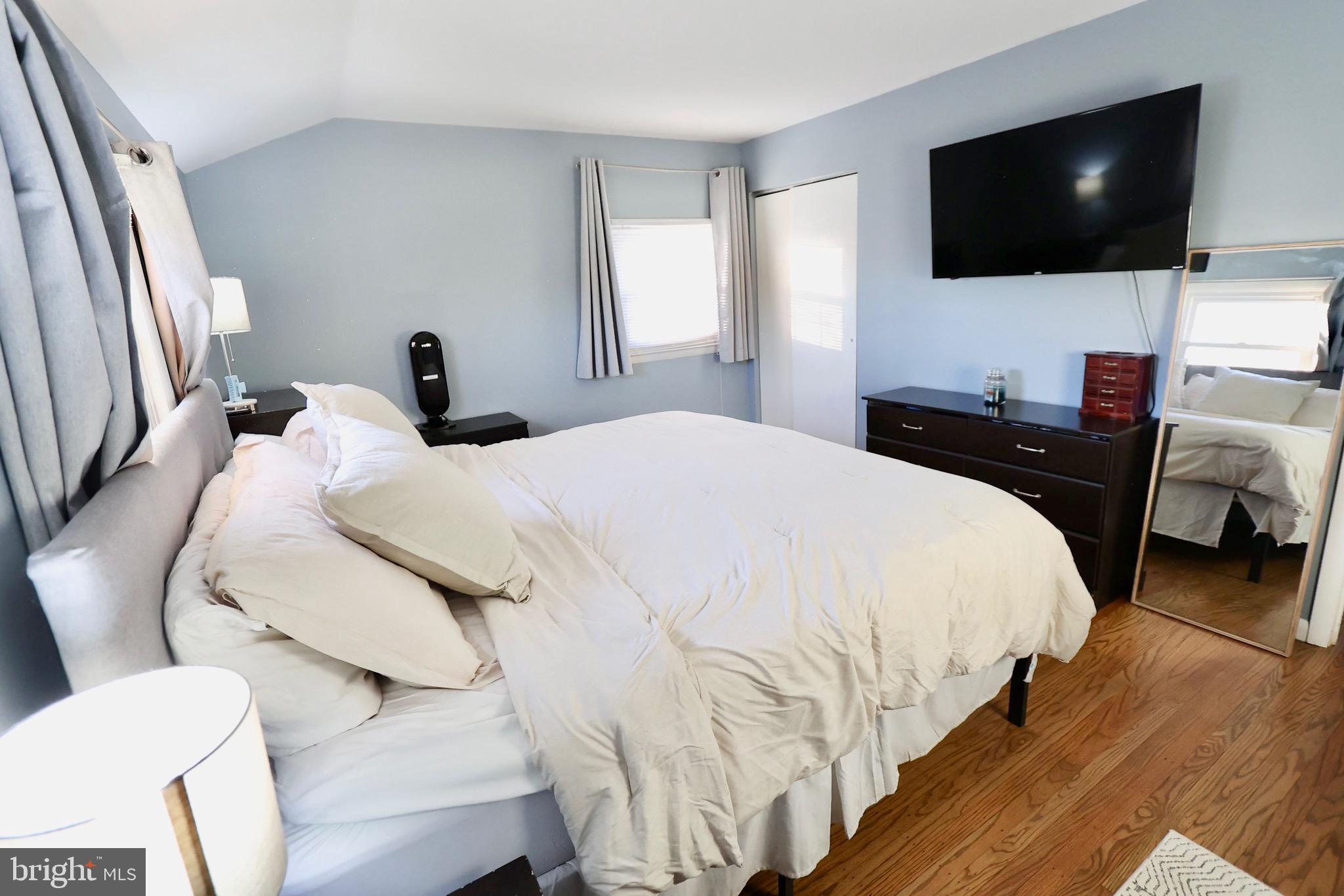 1036 Surrey Road Somerdale, NJ 08083 - Photo 10 of 23 a bedroom with a bed and a flat screen tv