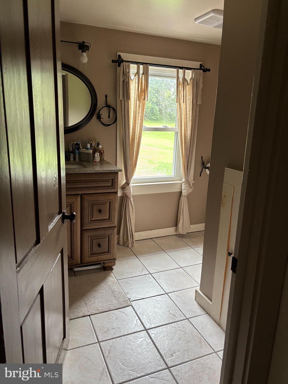 290 Woods Road Abbottstown, PA 17301 - Photo 16 of 49 a bathroom with a granite countertop sink a toilet and a mirror