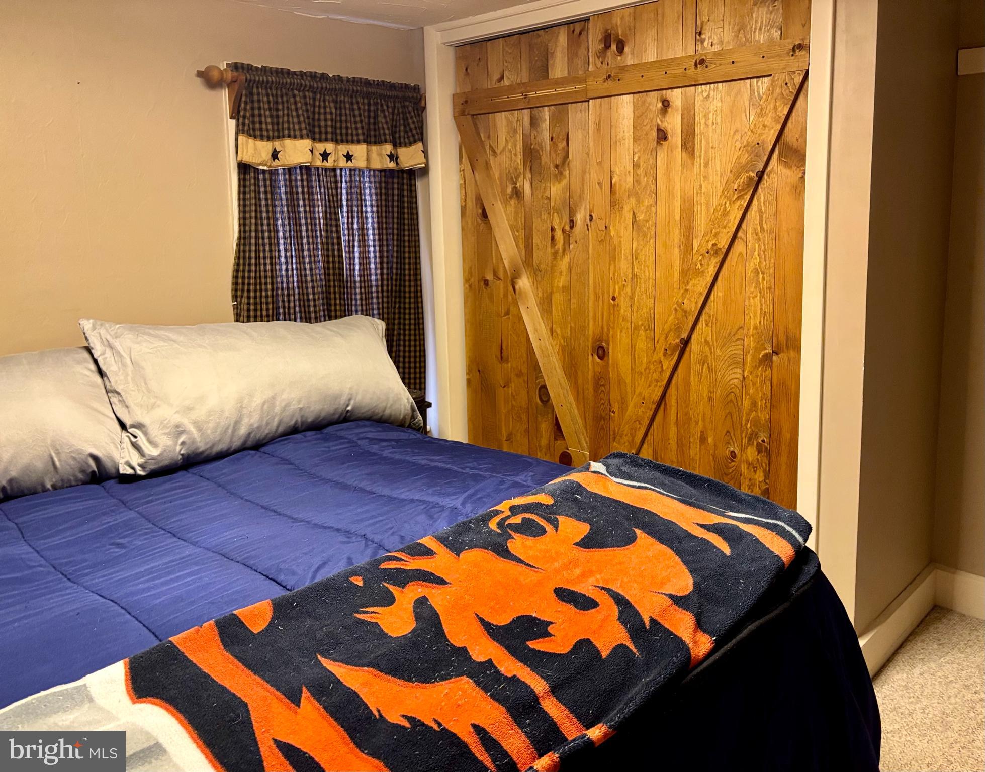 290 Woods Road Abbottstown, PA 17301 - Photo 19 of 49 a bedroom with a bed and a mirror