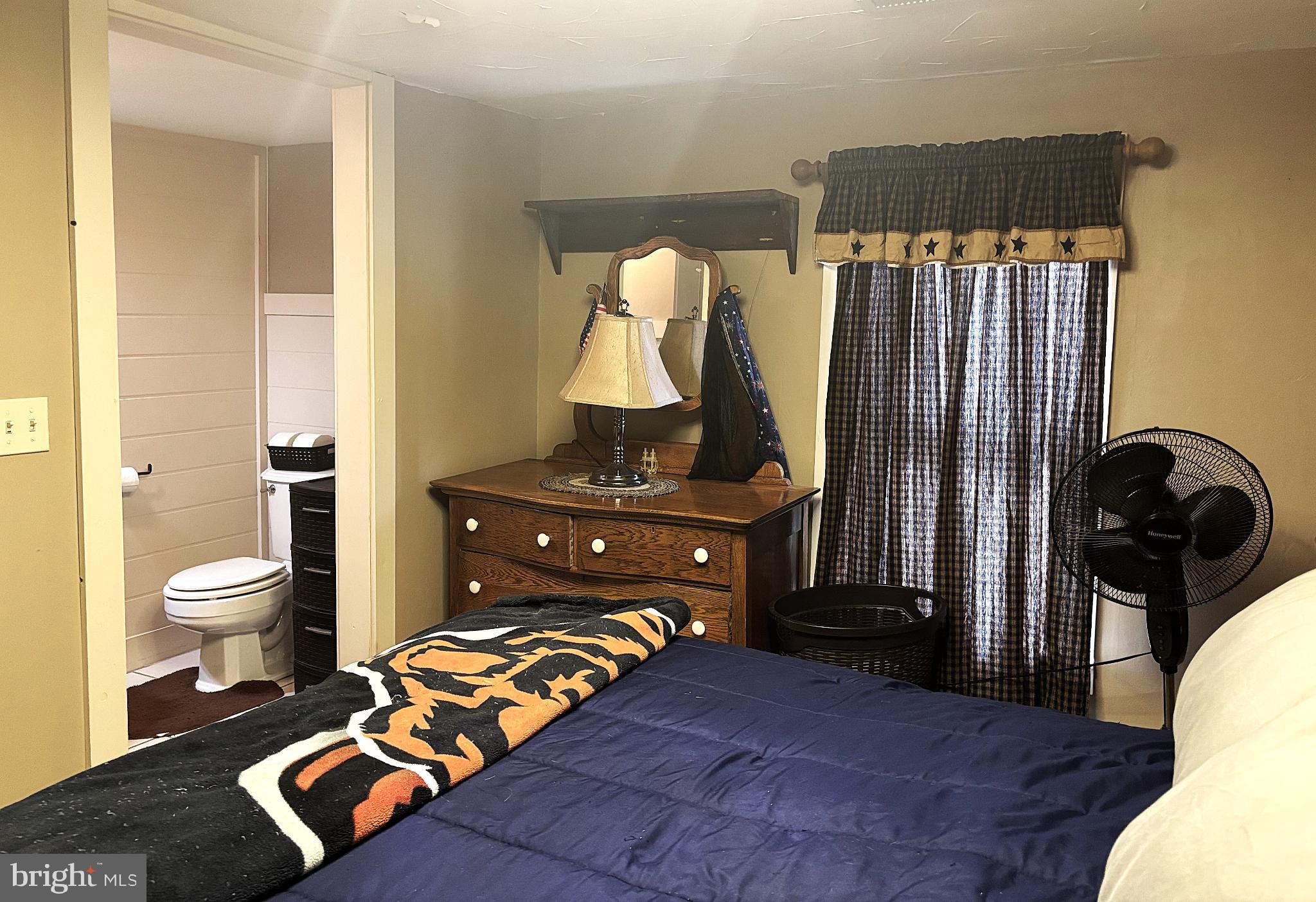 290 Woods Road Abbottstown, PA 17301 - Photo 20 of 49 a bedroom with a bed and wooden floor