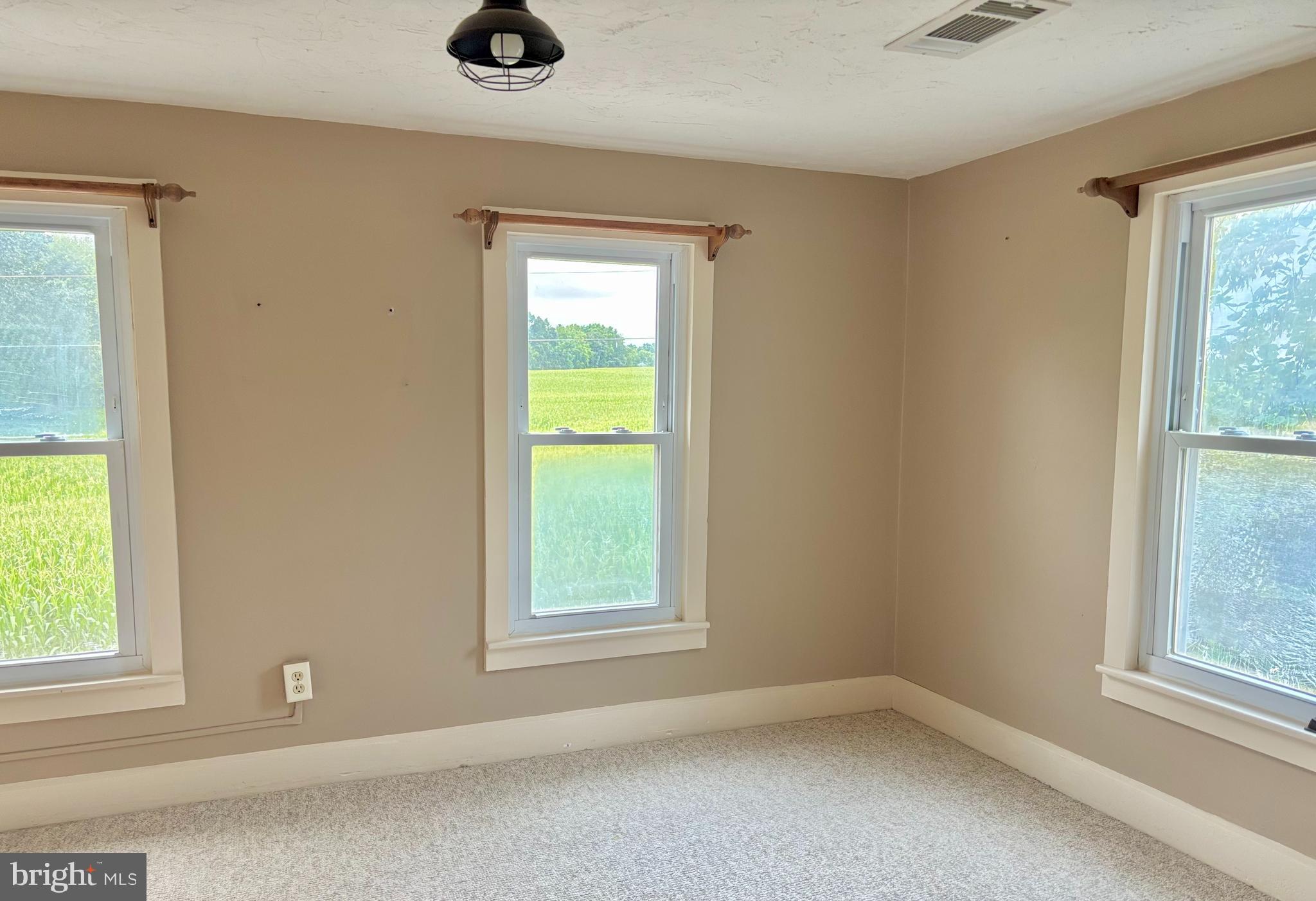 290 Woods Road Abbottstown, PA 17301 - Photo 23 of 49 an empty room with a window and a ceiling fan