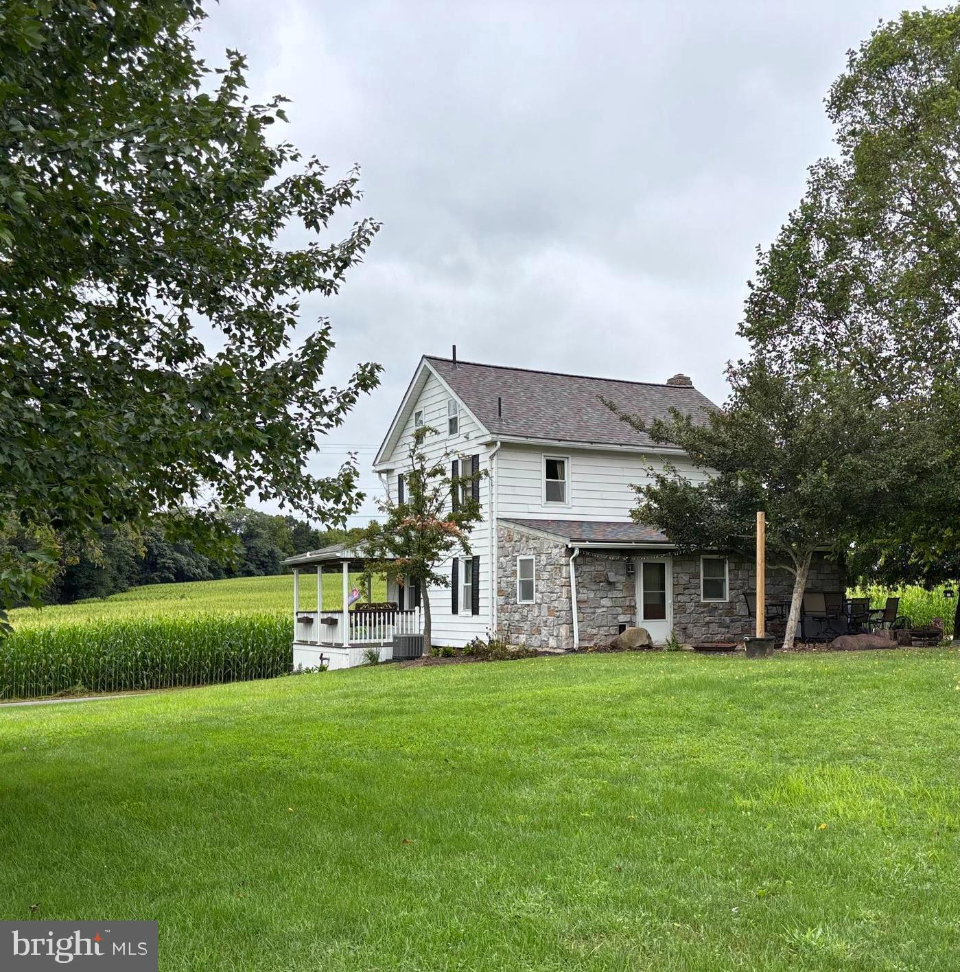 290 Woods Road Abbottstown, PA 17301 - Photo 3 of 49 a view of a big house with a big yard and large trees