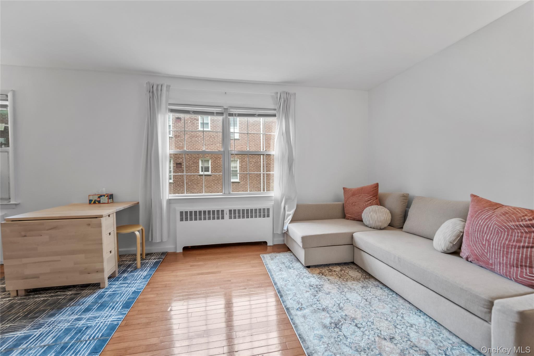 182 Pinewood Road, Unit 23 Hartsdale, NY 10530 - Photo 12 of 16 a living room with furniture and a rug